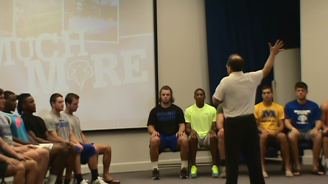 hypnotist Chris Cady  doing hypnosis with a football mental game toughness 